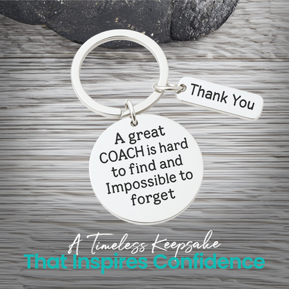 Silver coach keychain with engraved A Great Coach Is Hard to Find But Impossible to Forget pendant on rustic wood