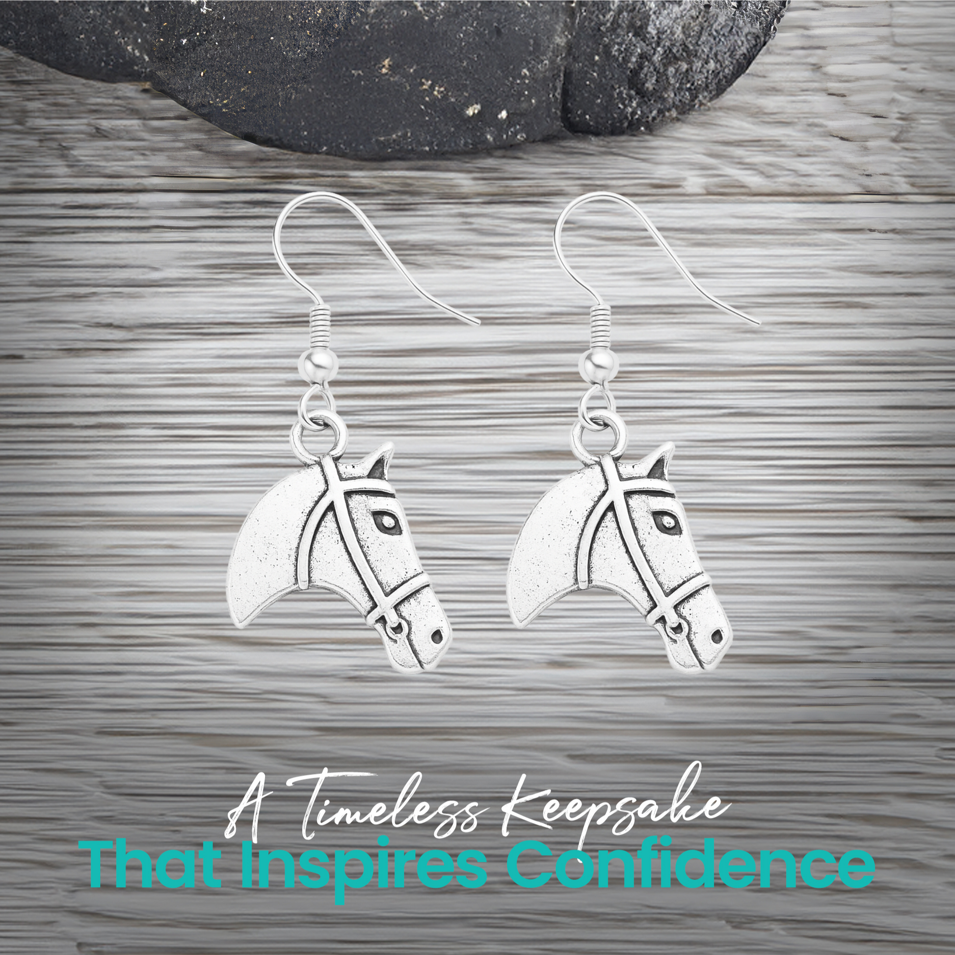 Silver horse head charm earrings displayed on rustic wood surface