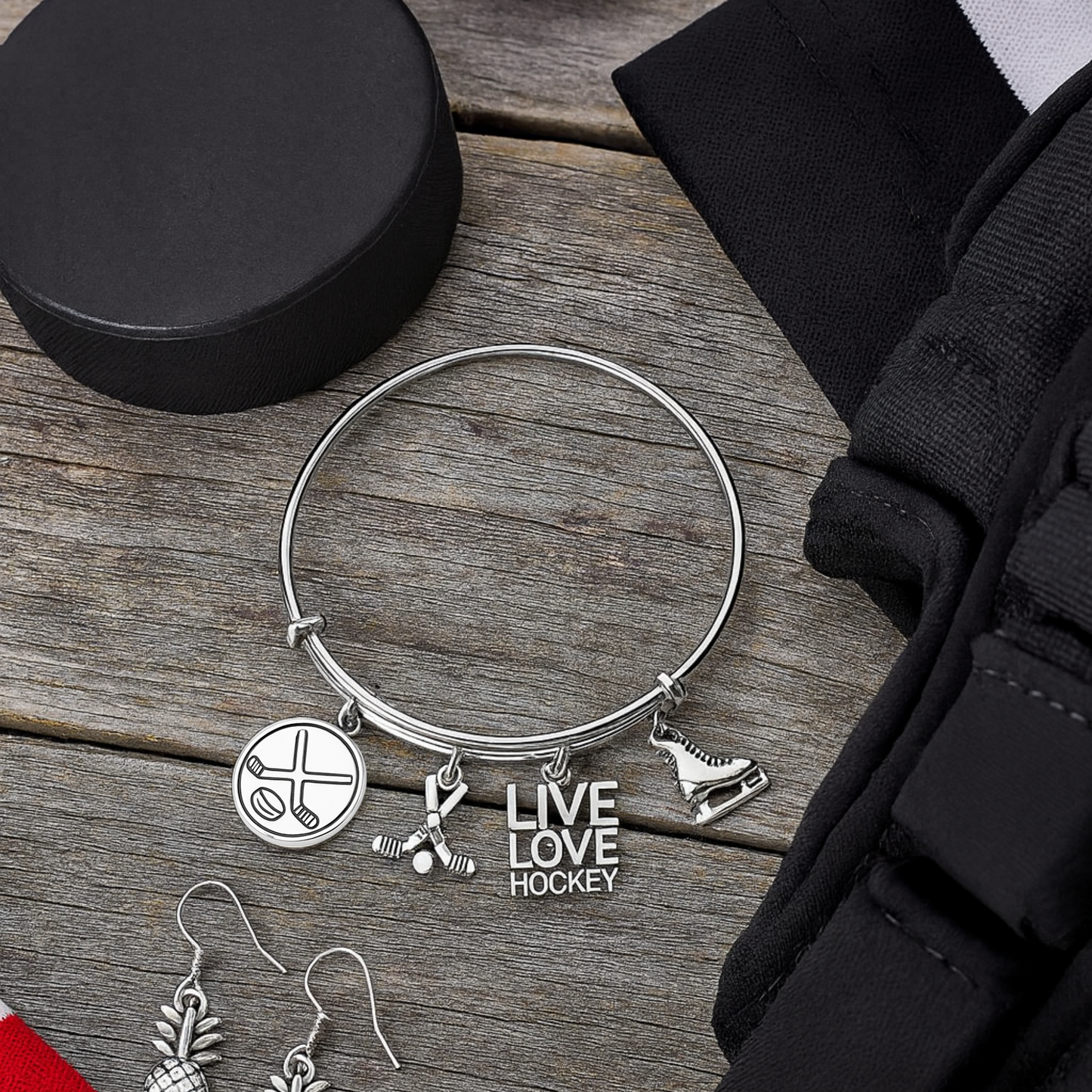 Hockey-themed charm bangle bracelet with silver charms and black velvet gift pouch