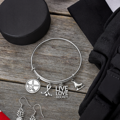 Hockey-themed charm bangle bracelet with silver charms and black velvet gift pouch