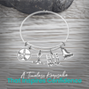 Adjustable silver hockey charm bracelet with puck, stick, and engraved charms
