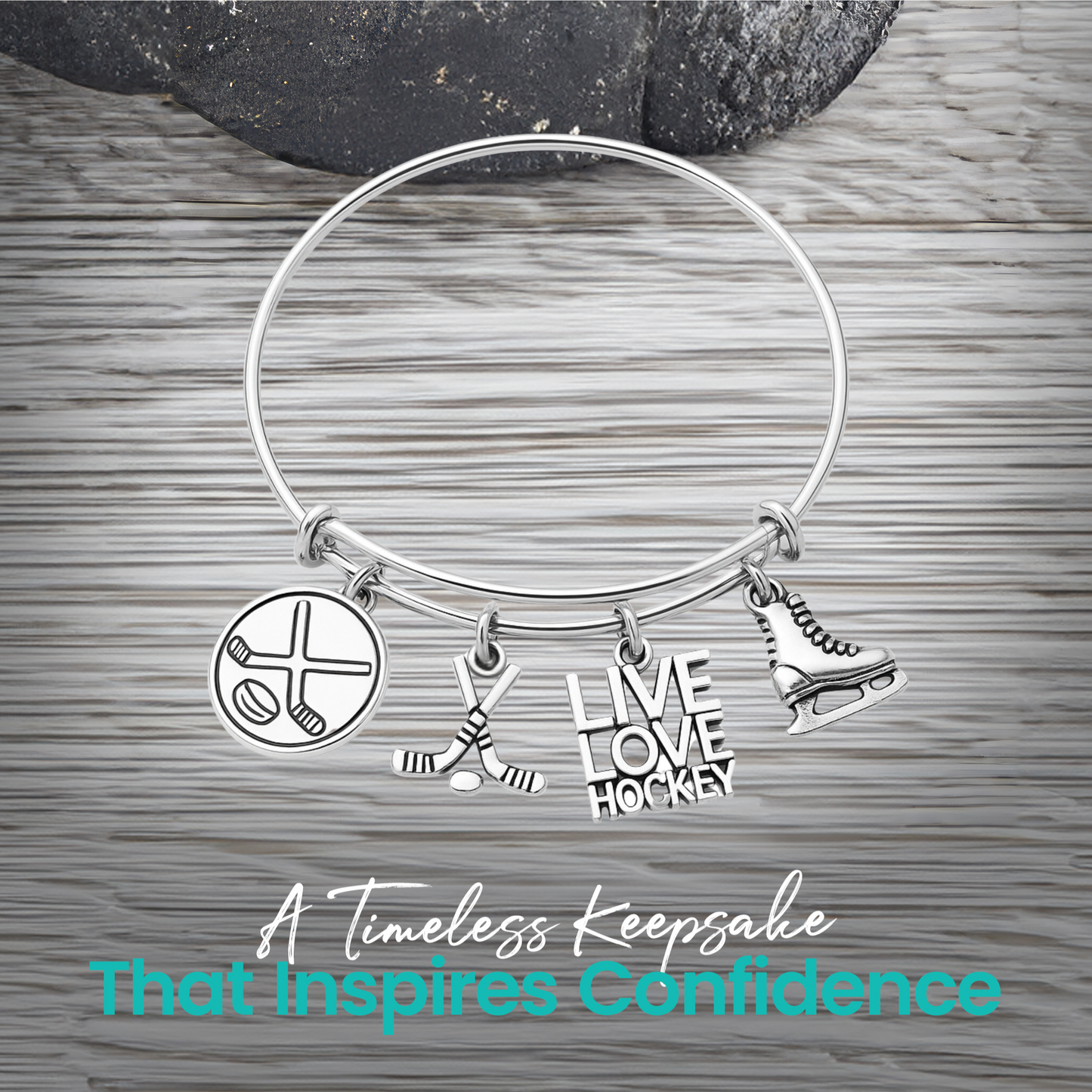 Adjustable silver hockey charm bracelet with puck, stick, and engraved charms