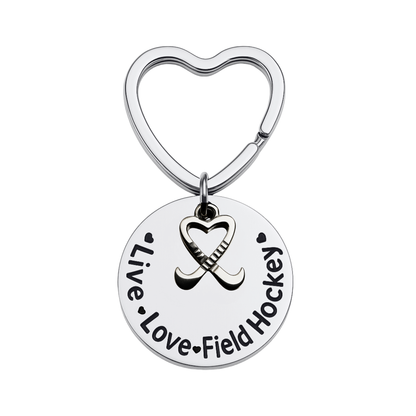 Silver heart-shaped keychain with engraved Live Love Field Hockey charm on white background