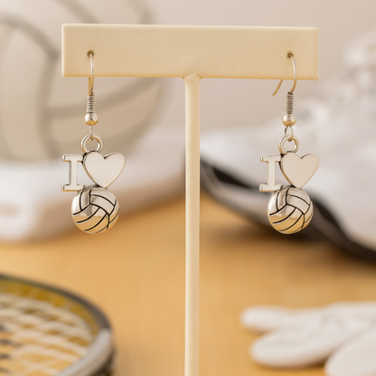 I Love Volleyball charm earrings hanging from jewelry display stand