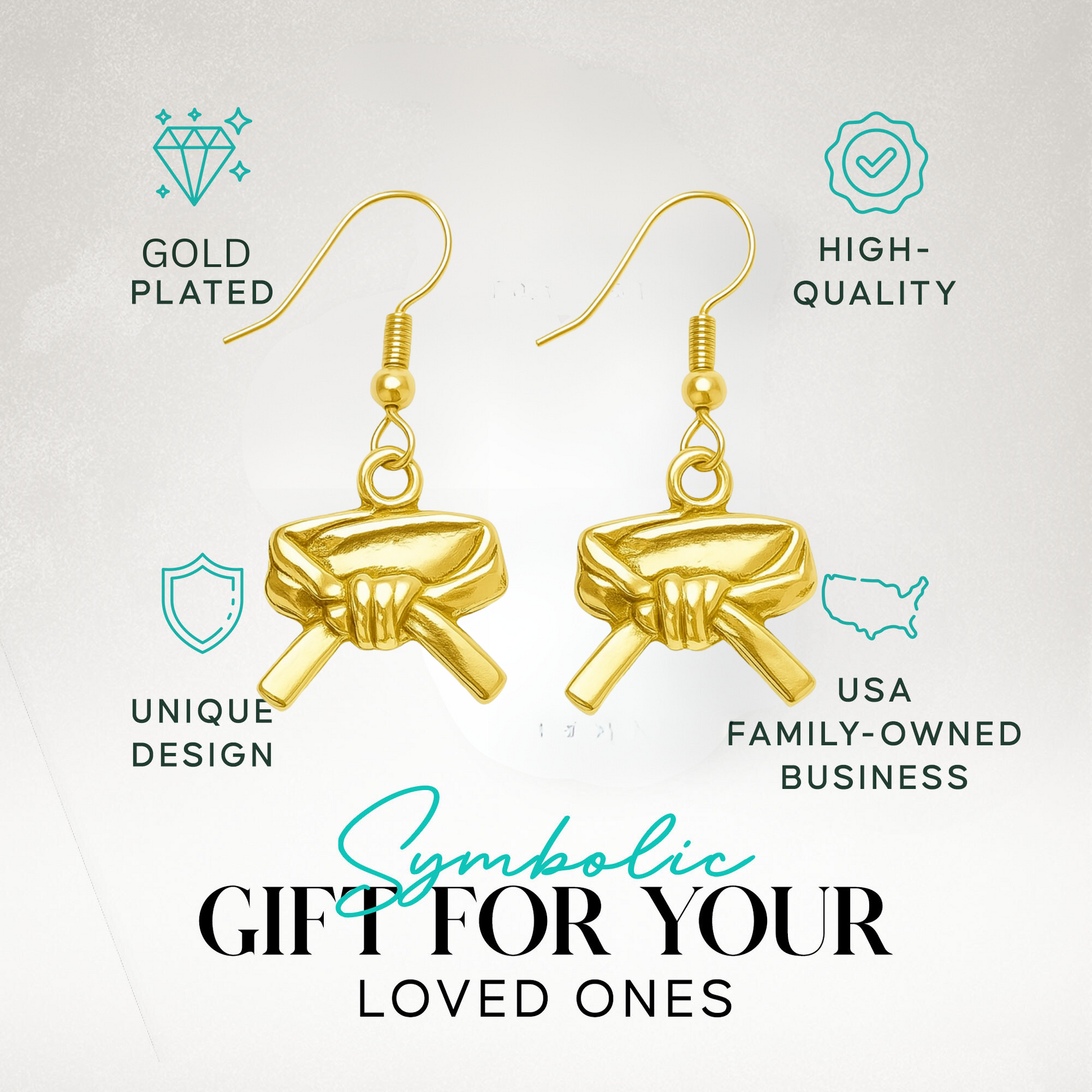 Close-up of gold martial arts belt earrings in premium display packaging with product icons