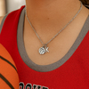 Teen girl wearing personalized basketball necklace with initial charm on jersey