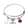 Adjustable silver field hockey bangle bracelet with letter charm, crossed sticks charm, and red birthstone charm