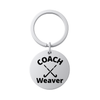 Stainless steel personalized field hockey coach keychain engraved with COACH Weaver on white background