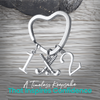 Silver heart-shaped field hockey keychain with crossed sticks and number charms on rustic wood