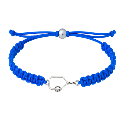 Blue bracelet with a silver pickleball paddle charm laid flat