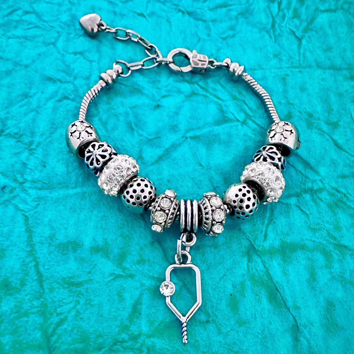 Silver Pickleball Charm Beaded Bracelet on Blue Background