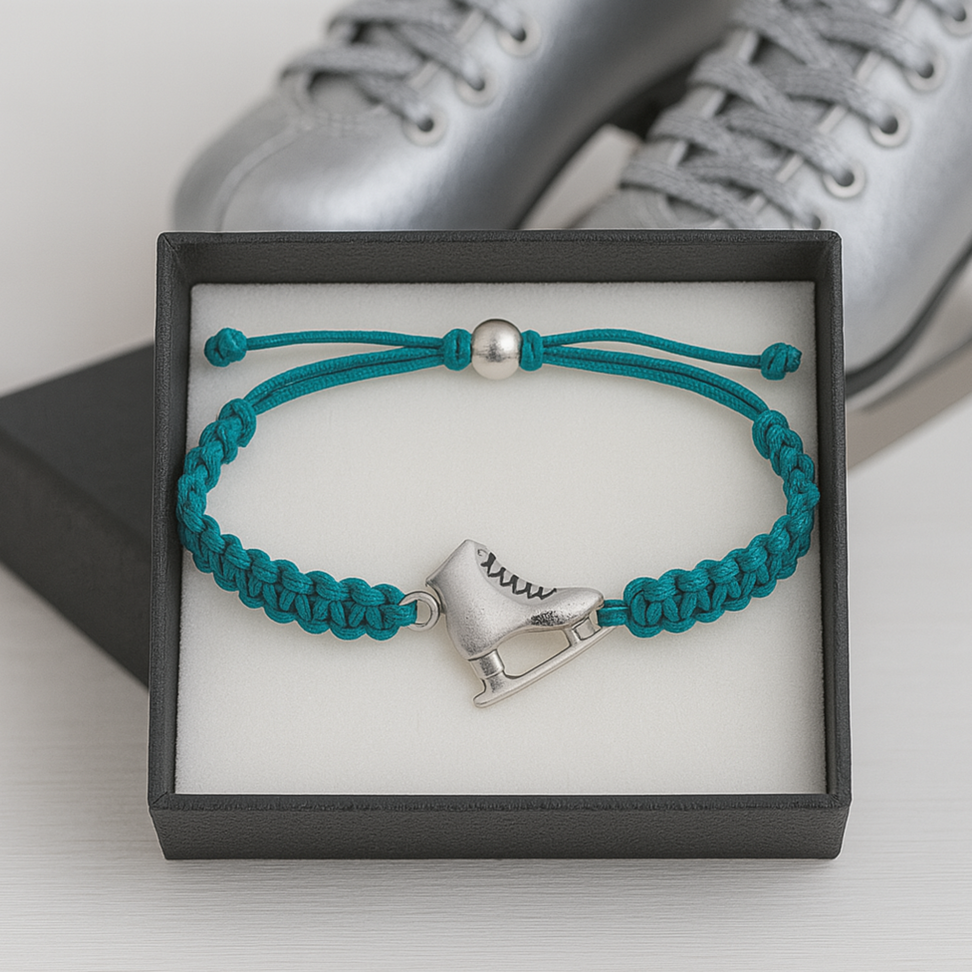 Turquoise skate bracelet resting on figure skates, ready for gifting