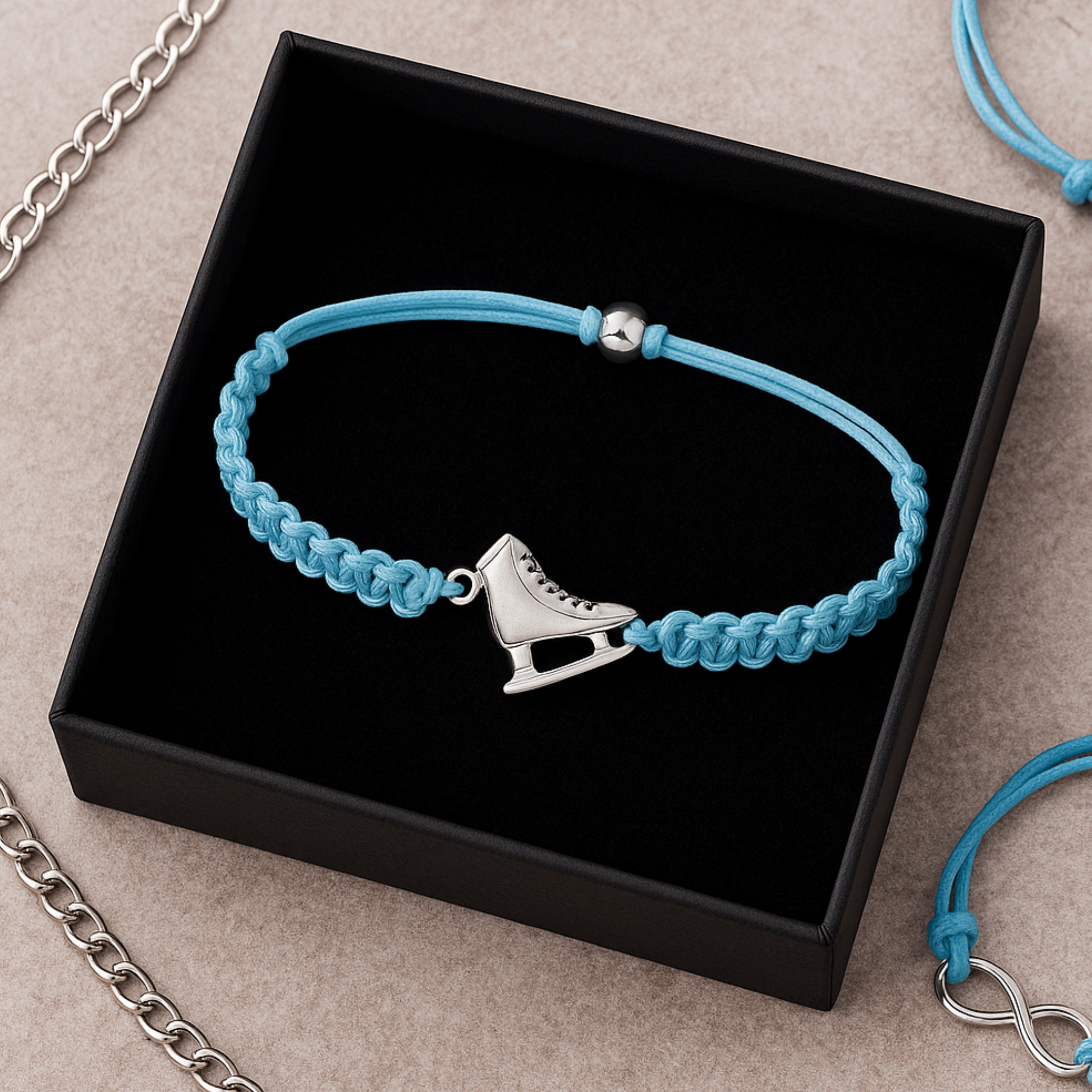 Blue ice skate charm bracelet presented in jewelry box on textured background