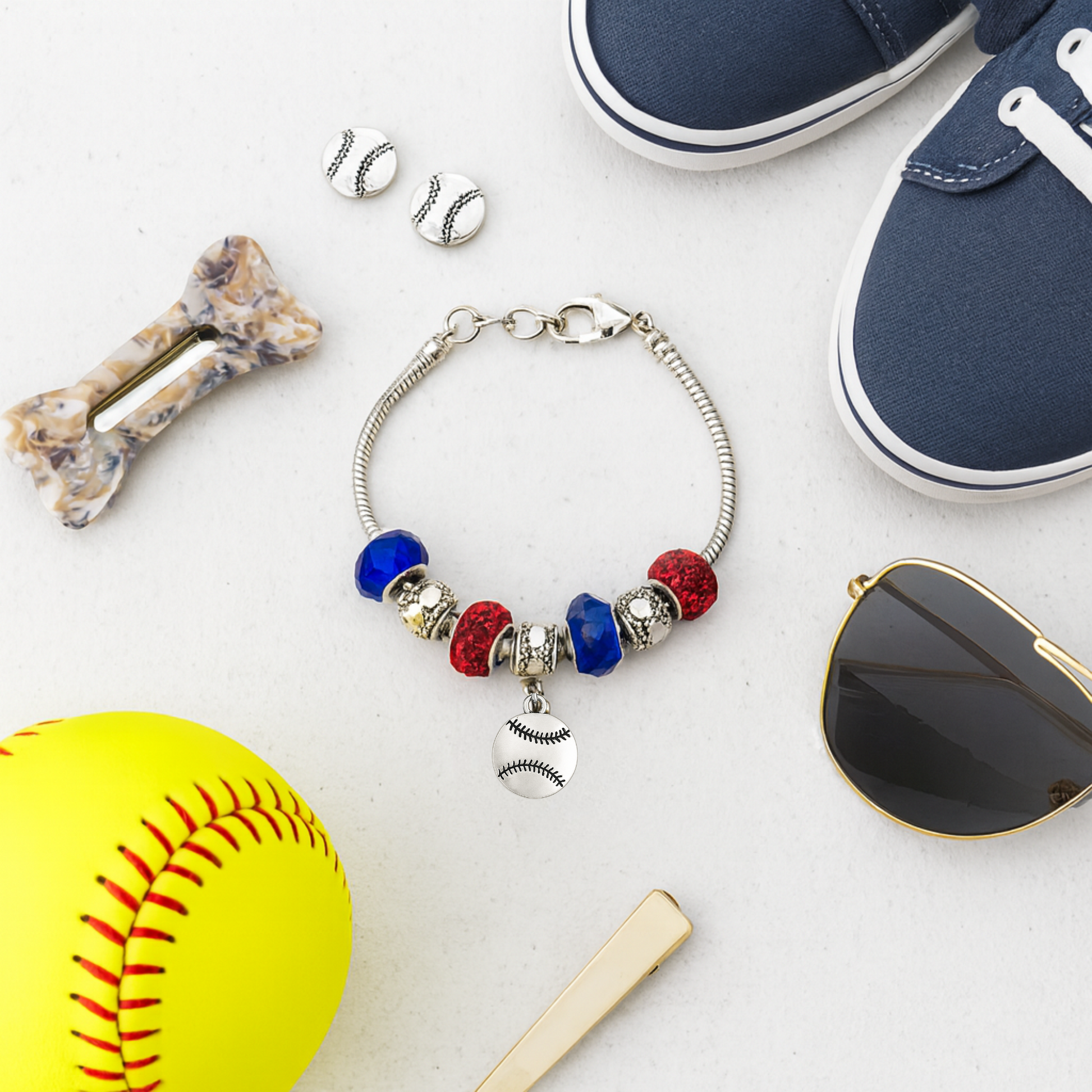Softball charm bracelet with colorful beads displayed next to softball and bat