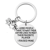 Inspirational softball mom keychain with glove and ball charms attached to ring