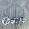 Motivational girls swimming bracelet with silver charms displayed on rustic wooden background