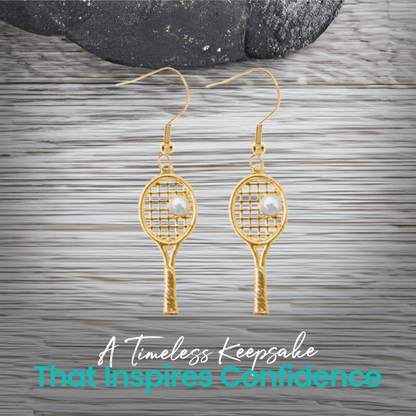 Gold tennis racket pearl earrings styled on rustic background