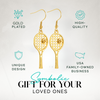 Gold tennis racket dangle earrings displayed with gift packaging