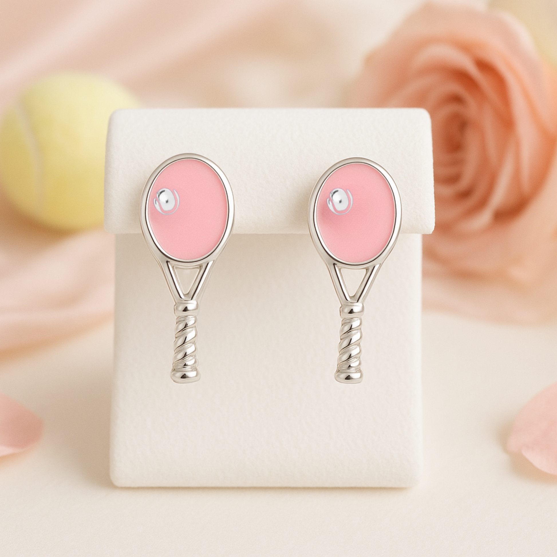 pink tennis racquet stud earrings on red background for tennis gift