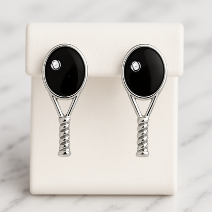 Black tennis racquet stud earrings displayed on earring card
