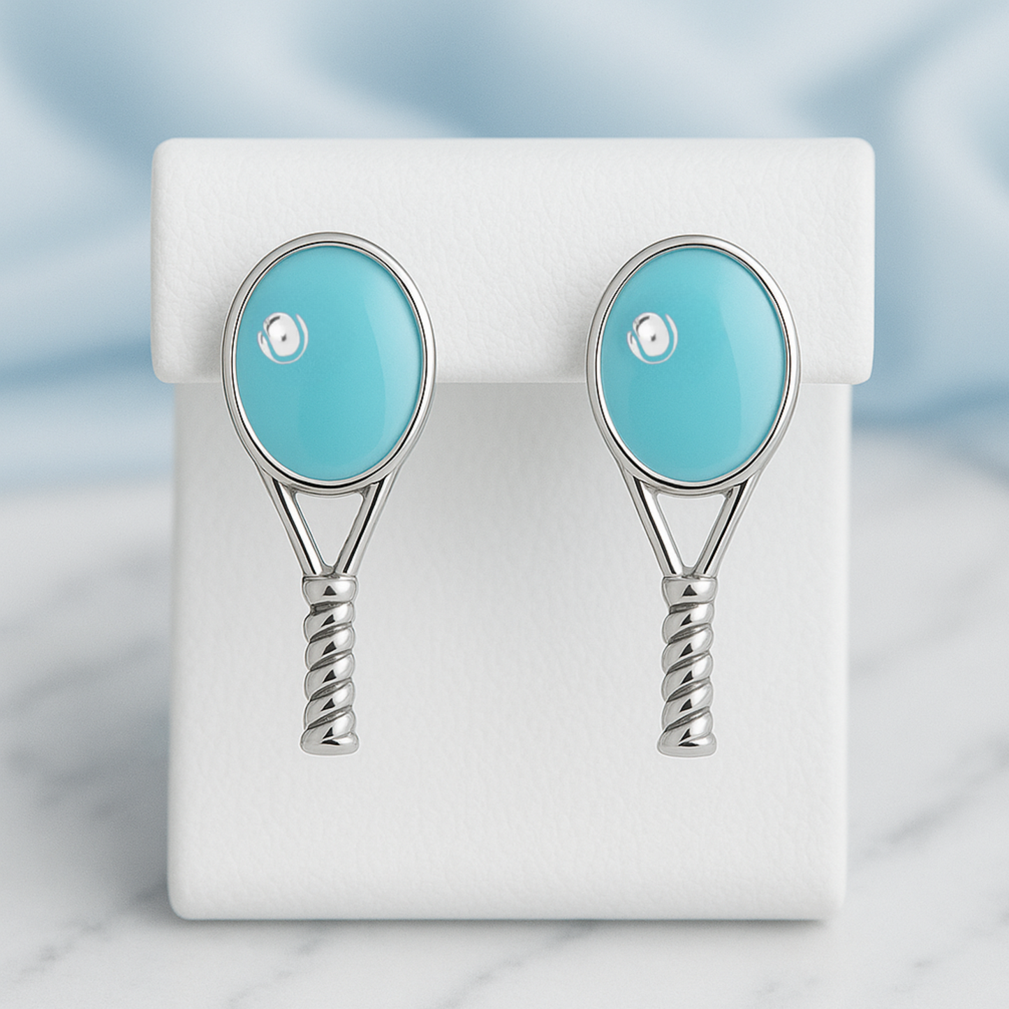 Turquoise tennis racquet stud earrings displayed for tennis gift
