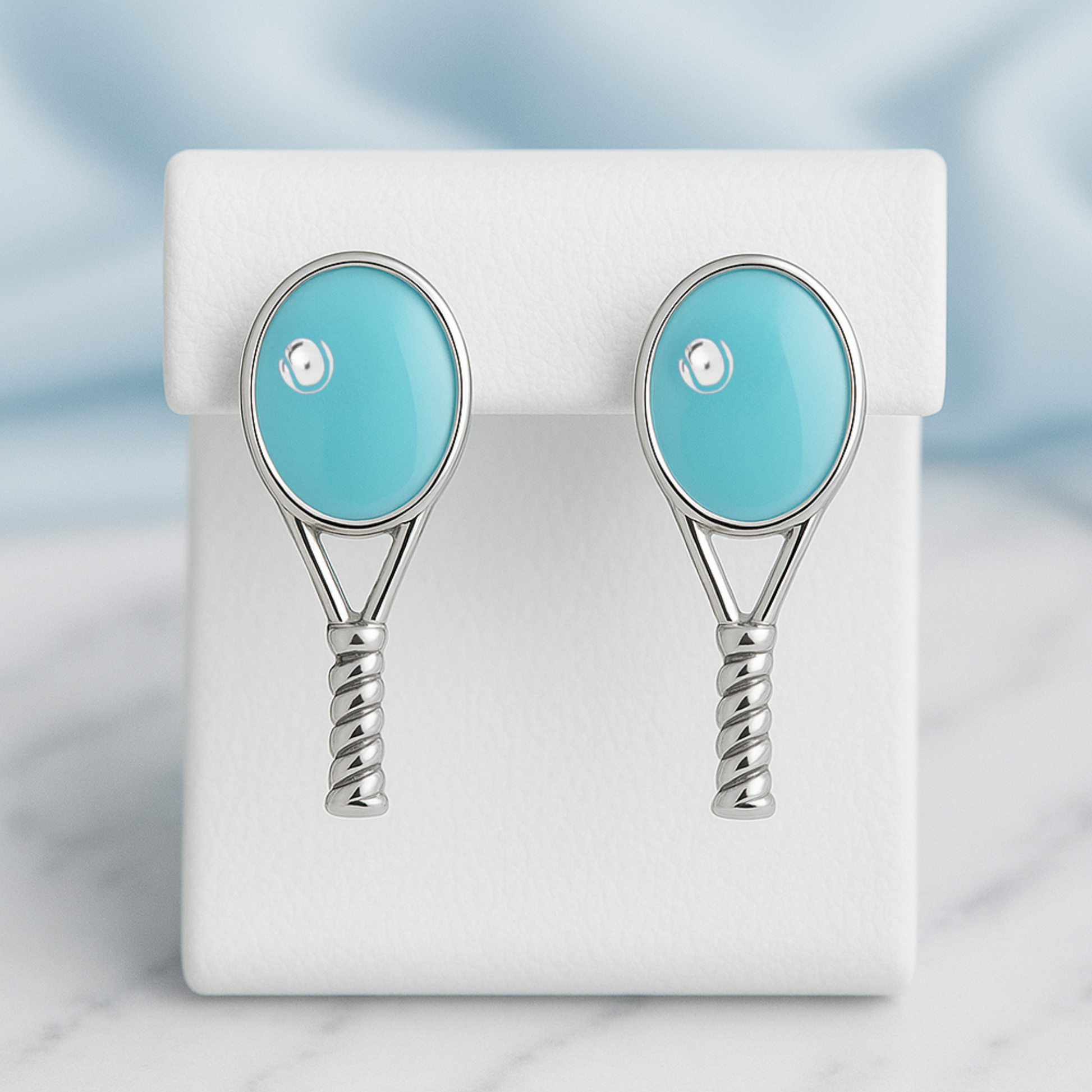 Turquoise tennis racquet stud earrings displayed for tennis gift