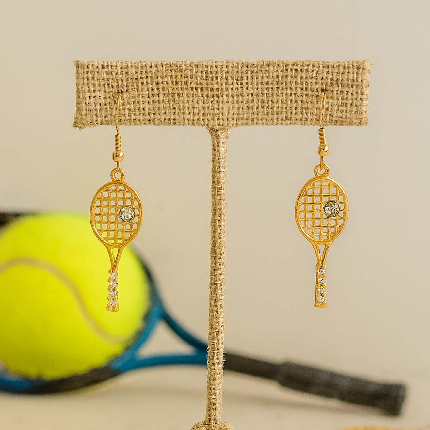 Gold tennis racket earrings with rhinestone detail on fishhook ear wires