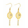 Gold-plated tennis racket rhinestone dangle earrings displayed with tennis ball