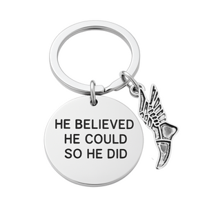 Silver track and field keychain with 'He Believed He Could So He Did' charm and running shoe pendant