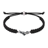 Black rope bracelet featuring silver sneaker charm laid flat on white background