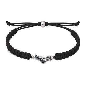 Black rope bracelet featuring silver sneaker charm laid flat on white background