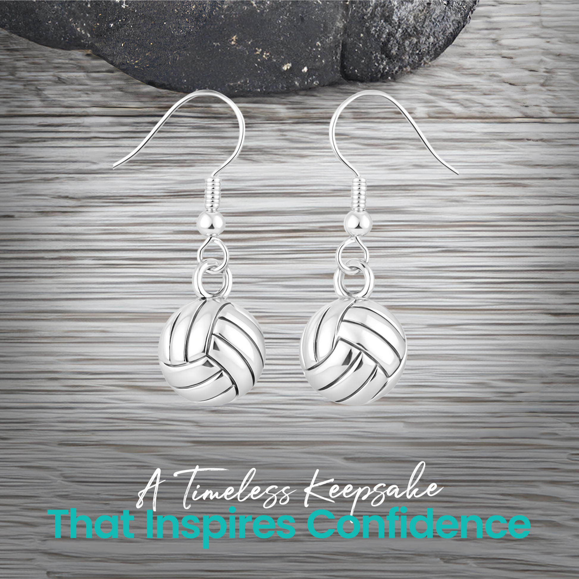 Silver volleyball drop earrings with french hook displayed on rustic wooden surface