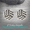 Pair of rhinestone volleyball earrings shown on gray wood surface, trendy everyday sports accessory for athletes