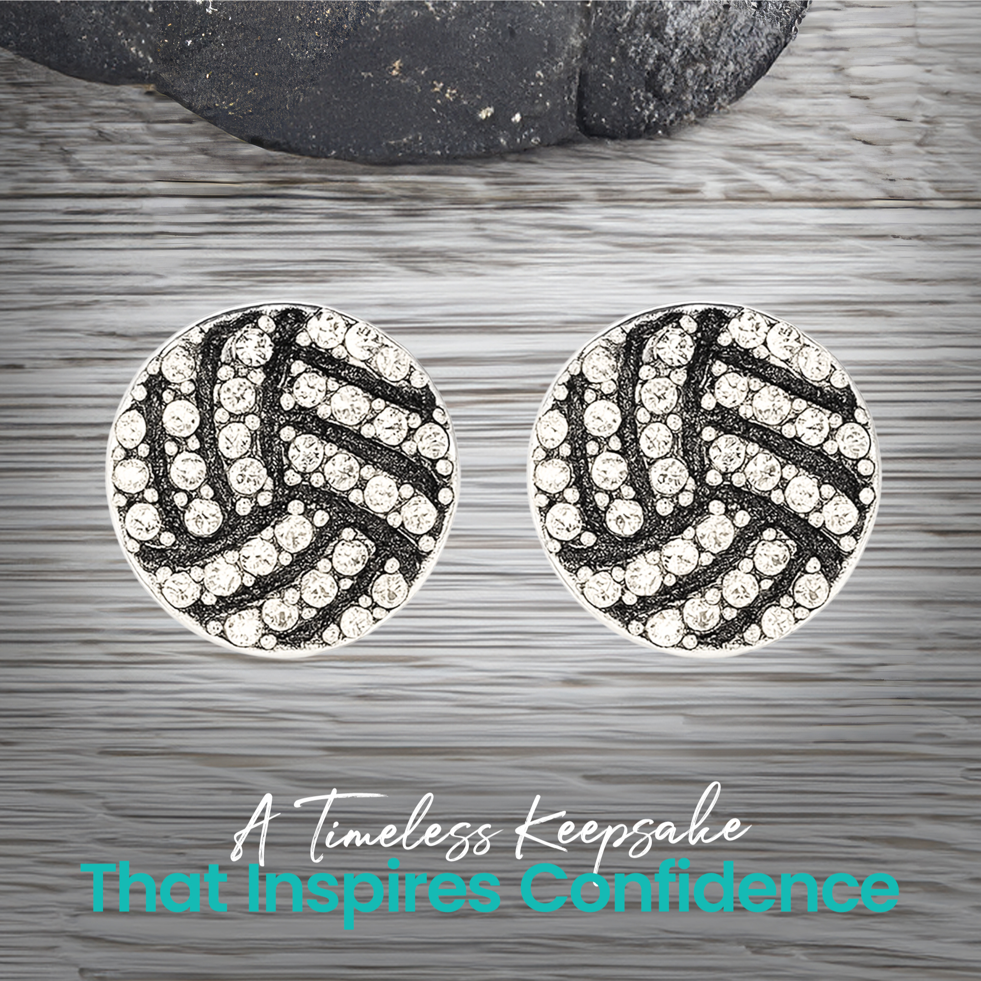 Pair of rhinestone volleyball earrings shown on gray wood surface, trendy everyday sports accessory for athletes