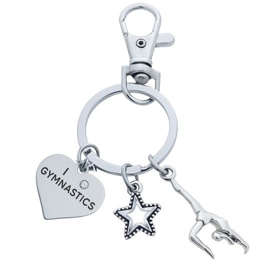Gymnastics keychain with silver heart charm, star charm, and gymnast figure charm on a lobster clasp key ring.