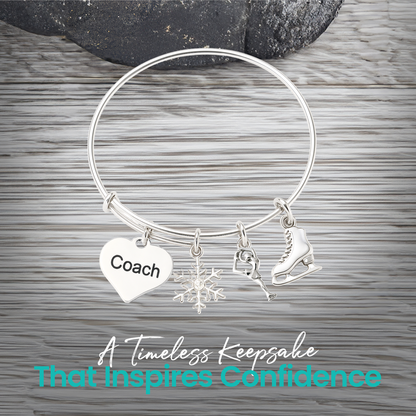 Figure skating bangle bracelet with coach heart charm displayed on rustic gray wooden surface