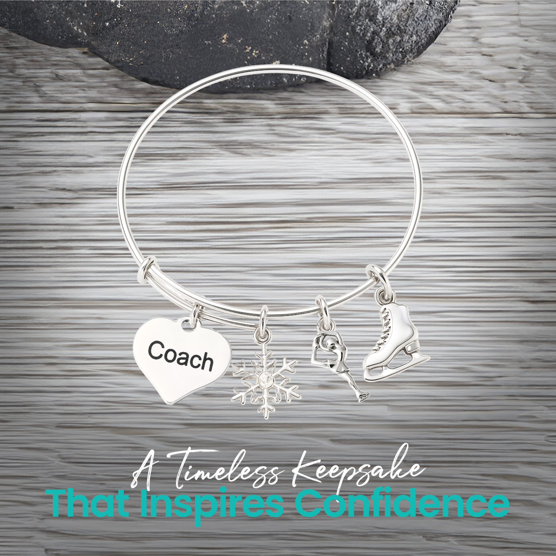 Figure skating bangle bracelet with coach heart charm displayed on rustic gray wooden surface
