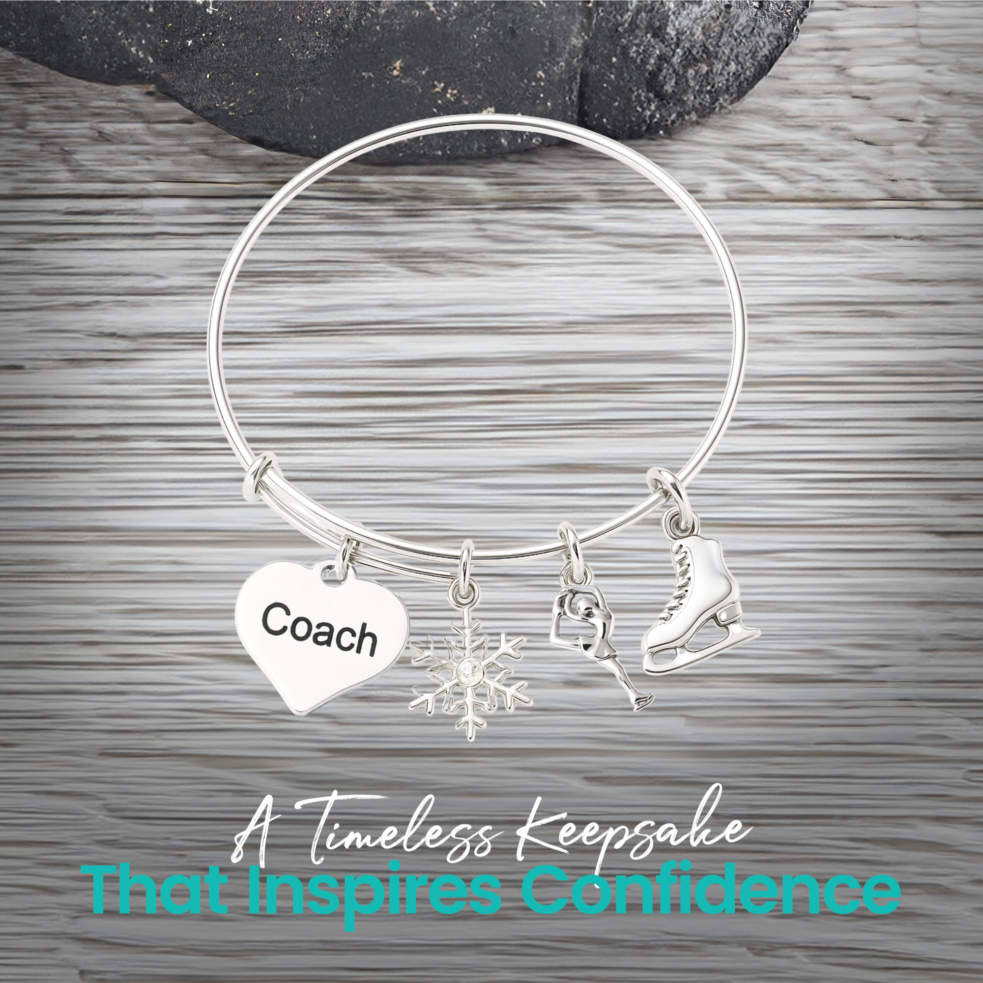 Figure skating bangle bracelet with coach heart charm displayed on rustic gray wooden surface