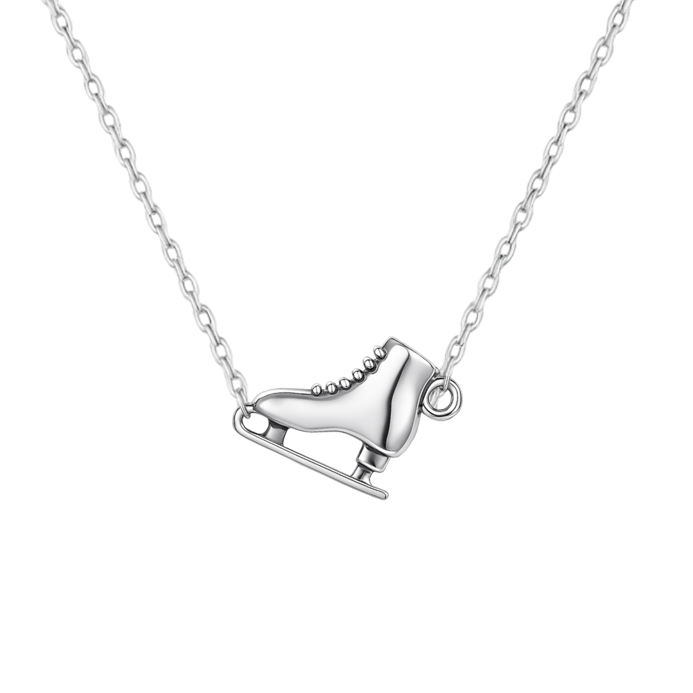 Close-up of ice skate necklace pendant on silver chain, displayed on white background