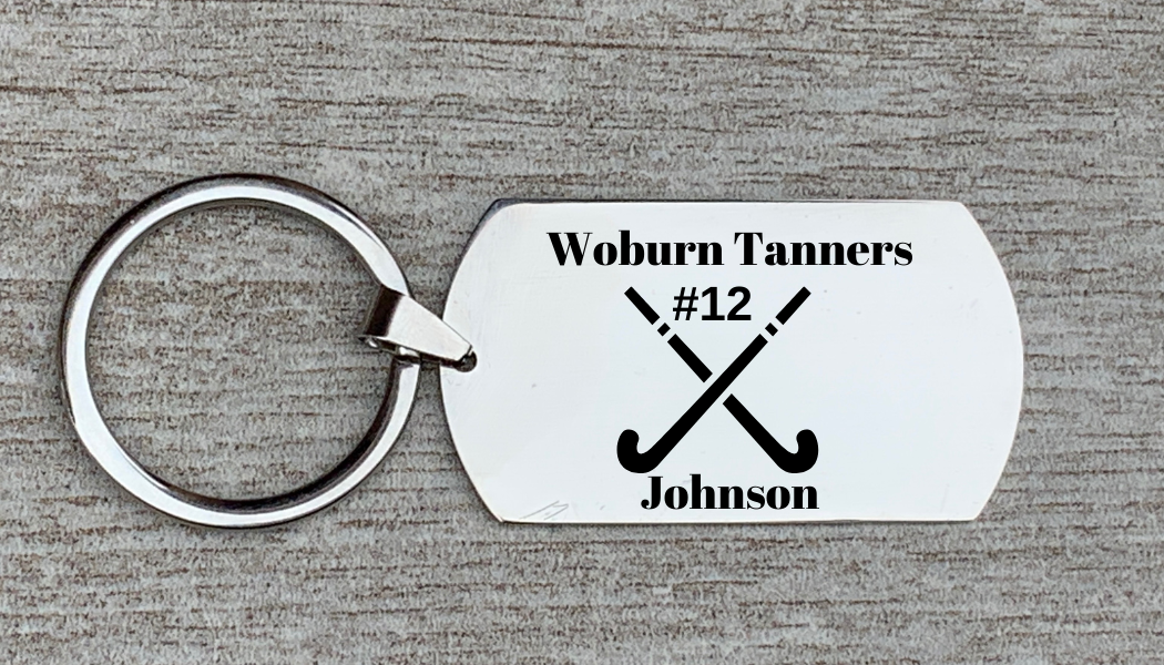 Engraved stainless steel field hockey dog tag keychain attached to silver keyring