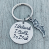 Detailed view of silver running shoe charm and 'I Believed I Could So I Did' motivational disc