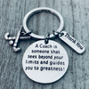 Round engraved charm reading A Coach Sees Beyond Your Limits on keychain with field hockey sticks charm