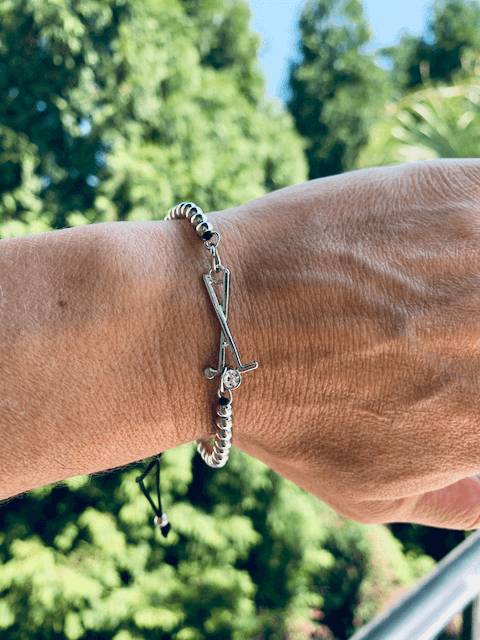 Women’s adjustable golf bracelet featuring silver beads and crossed golf club charm with rhinestone
