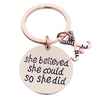 Rose gold plated field hockey keychain with crossed sticks charm and engraved She Believed She Could So She Did pendant