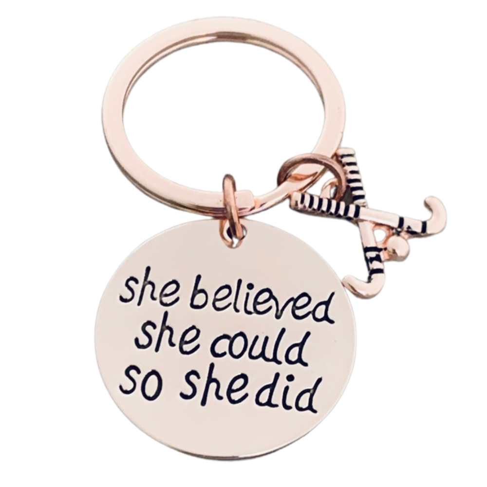 Rose gold plated field hockey keychain with crossed sticks charm and engraved She Believed She Could So She Did pendant