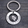 Softball charm keychain shown on rustic wood background, ideal accessory for athletes and sports moms