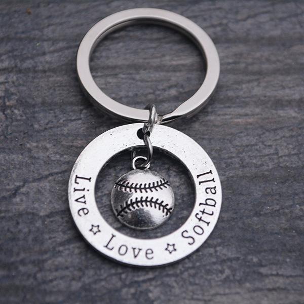 Softball charm keychain shown on rustic wood background, ideal accessory for athletes and sports moms