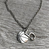 Basketball charm necklace with number 5 laid flat on rustic wooden surface