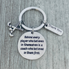 Round engraved charm reading Behind Every Player quote from field hockey coach keychain