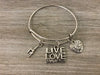 Live Love Gymnastics bangle bracelet displayed on wooden background